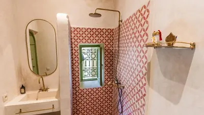 a bathroom with a sink and a mirror at Riad Dar Tiflet in Marrakech