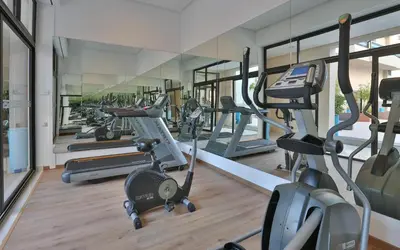 a gym with several treadmills and elliptical machines at Kech Boutique Hotel in Marrakech