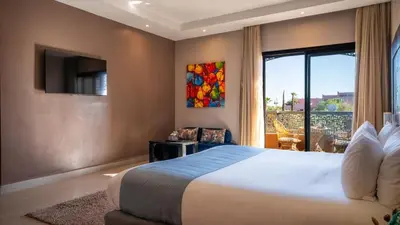 a bedroom with a large bed and a window at Kech Boutique Hotel in Marrakech