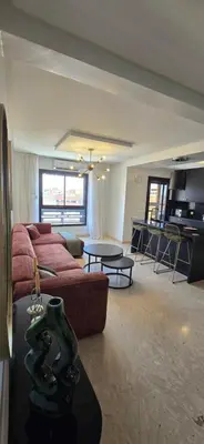 a living room with a couch and a table at Luxueux appartement entre Gueliz et l'Hivernage avec WIFI in Marrakech