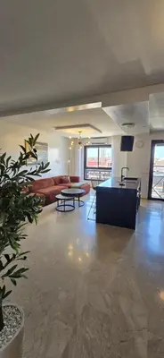 a living room with a couch and a table at Luxueux appartement entre Gueliz et l'Hivernage avec WIFI in Marrakech