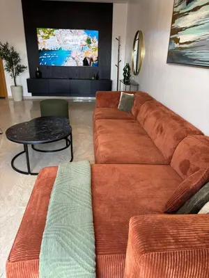 a living room with a couch and a table at Luxueux appartement entre Gueliz et l'Hivernage avec WIFI in Marrakech