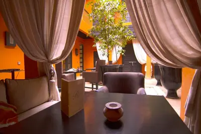 a table with a vase sitting on top of it at Riad Hermès in Marrakech