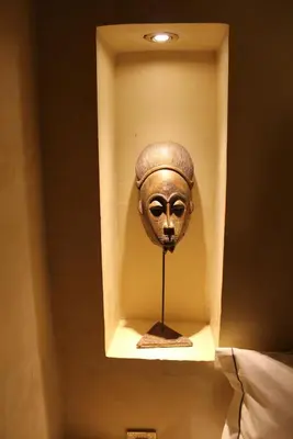 a mask in a box in a wall at Riad Hermès in Marrakech