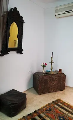 a room with a table and a mirror on the wall at Riad Ahlsouss in Marrakech