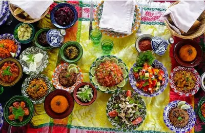 a table with many plates of food on it at Riad Espoir, Riad de charme en exclusivité dans la médina de Marrakech in Marrakech