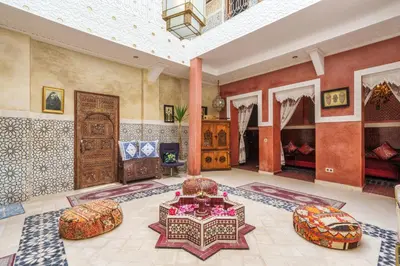 a living room with a large room with a table and chairs at Riad 7 chambres - Petit dejeuner gratuit in Marrakech