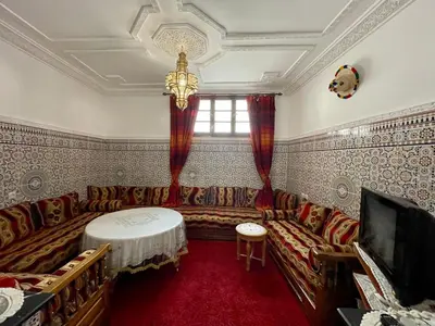 a living room with a couch and a tv at Cosy appartement in Marrakech