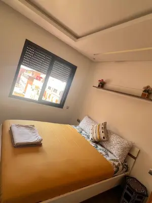 a small bedroom with a bed and a window at Appartement avec terrasse au calme en plein centre de Marrakech tres rare in Marrakech