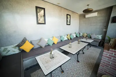 a room with a couch with pillows and tables at Riad Le Petit Joyau in Marrakech