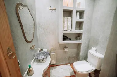 a small bathroom with a toilet and a sink at Riad Le Petit Joyau in Marrakech
