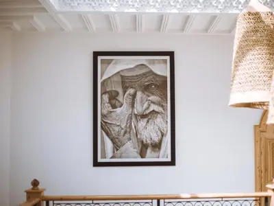 a picture of a statue on a wall in a room at Riad Le Petit Joyau in Marrakech