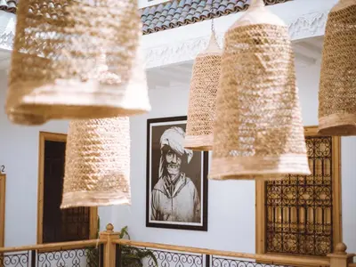 a group of wine glasses hanging from the ceiling of a room at Riad Le Petit Joyau in Marrakech