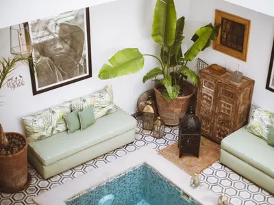 a living room with two couches and a pool at Riad Le Petit Joyau in Marrakech