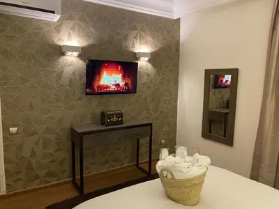 a room with a fireplace and a tv on a wall at Appartment Rhizlane in Marrakech