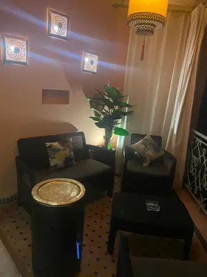 a living room with a couch and a table at Appartment Rhizlane in Marrakech