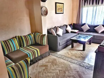a living room with a couch and a table at La Perle de l'Atlas by Golf Resort in Marrakech