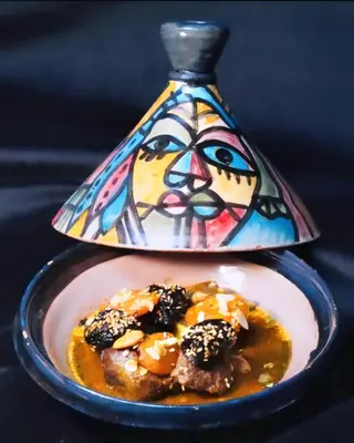 a plate of food with a vase on top at La Perle de l'Atlas by Golf Resort in Marrakech