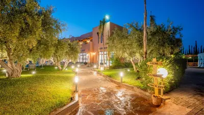 a street sign in front of a building at night at Ourika Camp Suites Hotel & Resort in Marrakech