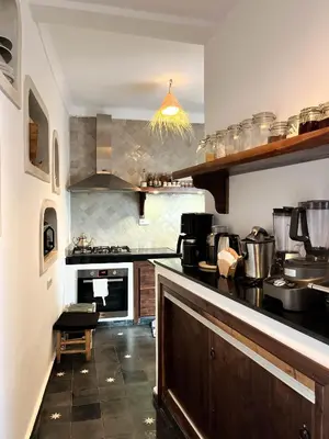 a large kitchen with a counter and a stove at Riad Darsahalia in Marrakech