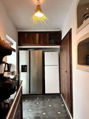 a kitchen with a white refrigerator and a ceiling at Riad Darsahalia in Marrakech