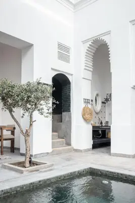 a villa with a pool in the middle of a house at Riad Darsahalia in Marrakech