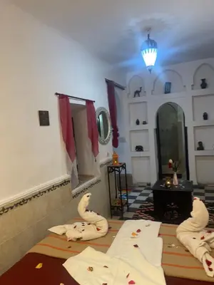 a room with two beds with swans on the floor at Riad Gaya in Marrakech