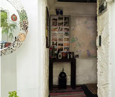 a hallway in a house with a table and a mirror at Riad Gaya in Marrakech