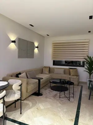 a living room with a couch and a table at Hivernage - Stylish APT in the Heart of the City in Marrakech
