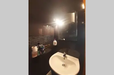 a bathroom with a white sink and a mirror at Hivernage - Stylish APT in the Heart of the City in Marrakech