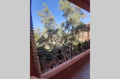 a balcony with a view of a tree at Hivernage - Stylish APT in the Heart of the City in Marrakech