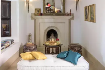 a living room with a couch and a fireplace at Riad Hayati in Marrakech