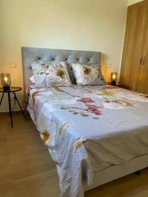 a bedroom with a large bed with flowers on it at La Perla de Marrakech Appart de Luxe in Marrakech
