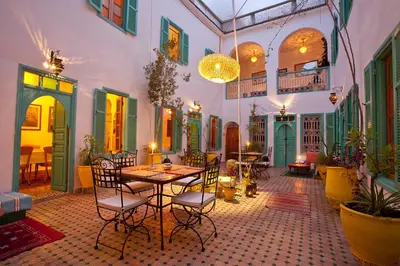 a room with a table and chairs in a building at Riad Dar Aida in Marrakech
