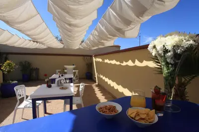 a blue table with a bowl of food on a patio at Riad Infinity Sea in Marrakech