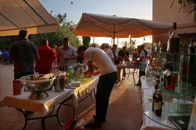 a group of people standing around tables with drinks at Valeria Madina Club - All Inclusive in Marrakech