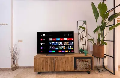 a television sitting on top of a wooden cabinet at Stylish Studio(WiFi, Netflix, Pool, AC, Nespresso) in Marrakech