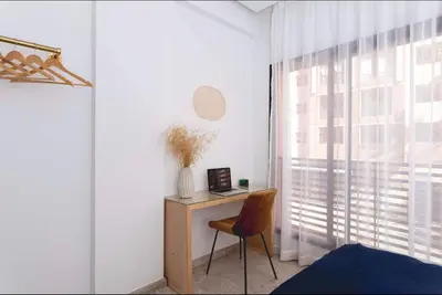 a desk with a chair in a room with a window at Stylish Studio(WiFi, Netflix, Pool, AC, Nespresso) in Marrakech