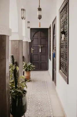 a hallway with a door and a potted plant at Riad Alnadine in Marrakech