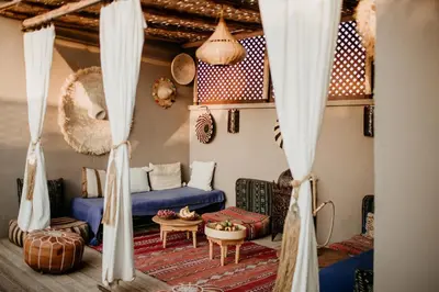 a living room with a blue couch and a table at Riad Alnadine in Marrakech