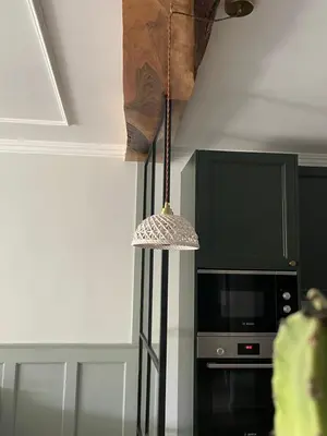 a pendant light hanging from a ceiling next to a tv at Chimera Apartments & Suites in Marrakech