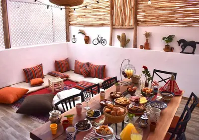a table with food and a couch in a room at COSY LUXURY Apartment - GUELIZ in Marrakech
