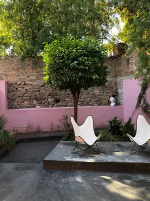 two chairs and a tree next to a wall at MORO Marrakech Boutique Hôtel in Marrakech