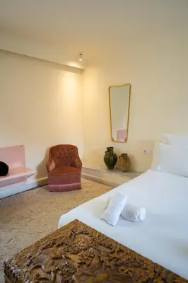 a bedroom with a large bed and a chair at MORO Marrakech Boutique Hôtel in Marrakech