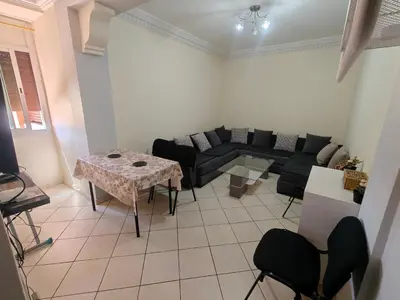 a living room with a couch and a table at Bright Air Conditioned Apartment Near City Center in Marrakech