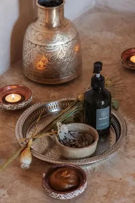 a table with a bottle of soap and a bowl of food at Riad Agathe & Spa in Marrakech