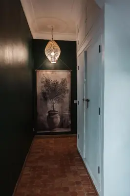 a hallway with a painting on the wall and a chandelier at Riad Agathe & Spa in Marrakech