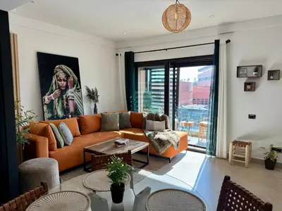a living room with a couch and a table at Zara Apartments Marrakech in Marrakech