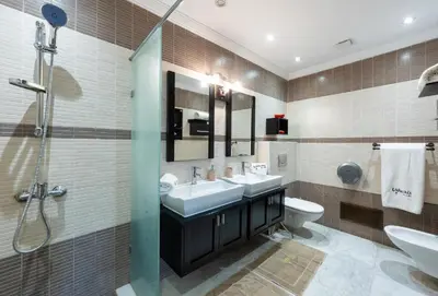 a bathroom with two sinks and a toilet and a shower at Villa avec piscine - Petit déjeuner Gratuit - Marrakech City Center in Marrakech