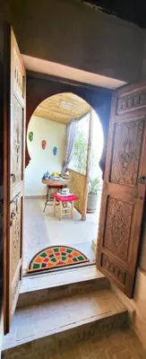 an entrance to a room with a table and a door at Riad Ayada in Marrakech